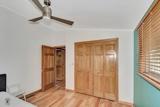 944 E County Line Rd, Beecher, IL 60401 - unfurnished bedroom with lofted ceiling, light wood-style floors, ceiling fan, and a closet