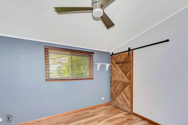 944 E County Line Rd, Beecher, IL 60401 - unfurnished room with lofted ceiling, a ceiling fan, a barn door, and light wood finished floors