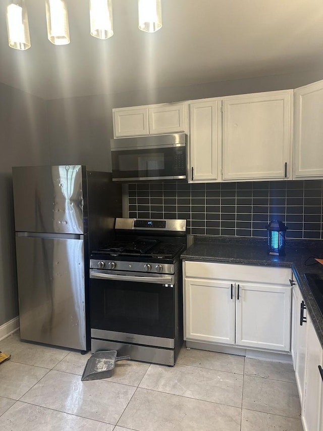 7618 S Drexel Ave, Chicago, IL 60619 - kitchen with stainless steel appliances, dark countertops, and backsplash