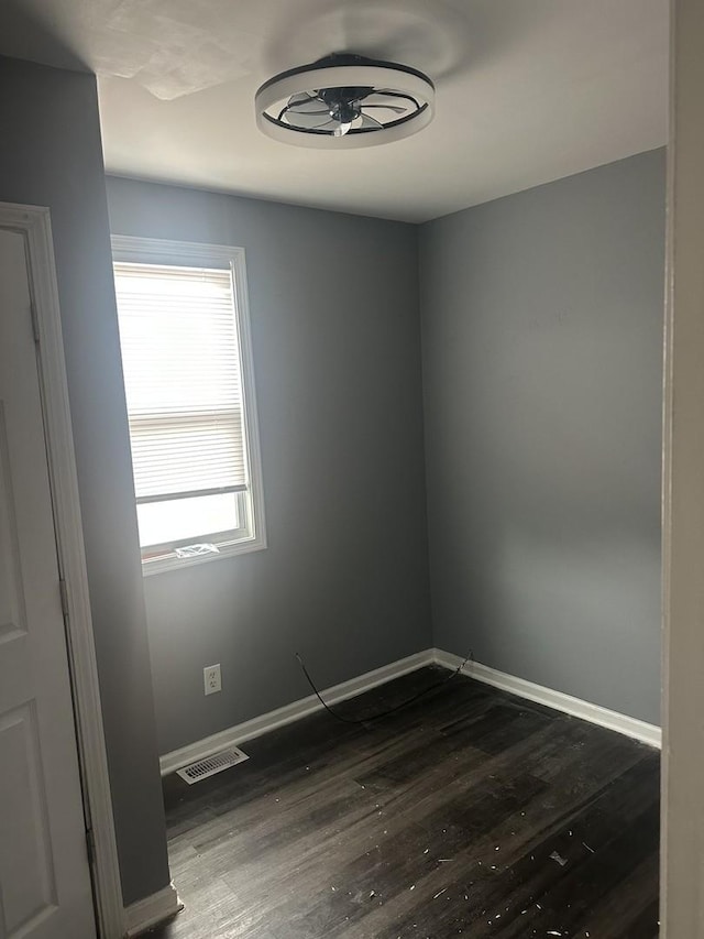 7618 S Drexel Ave, Chicago, IL 60619 - spare room featuring baseboards and dark wood finished floors