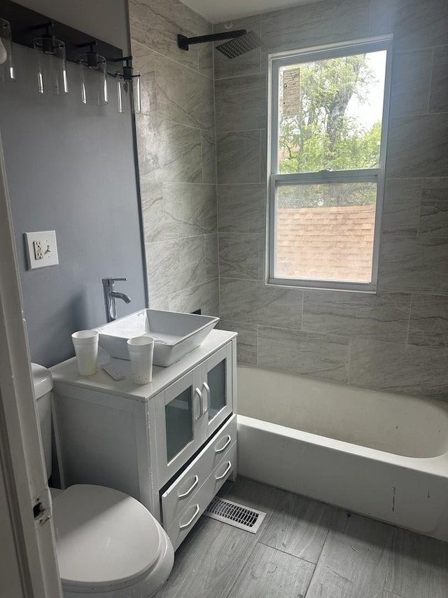 7618 S Drexel Ave, Chicago, IL 60619 - full bathroom featuring vanity, plenty of natural light,  shower combination, and wood finished floors