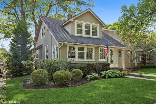 4628 Grand Ave, Western Springs, IL 60558 - view of front facade featuring stucco siding, a front yard, a shingled roof, and a chimney