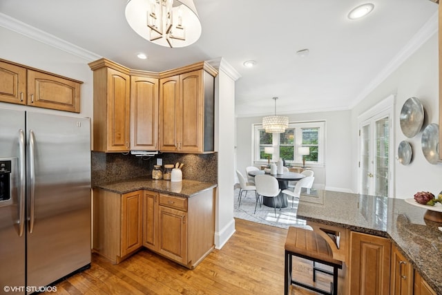 4628 Grand Ave, Western Springs, IL 60558 - kitchen featuring stainless steel fridge with ice dispenser, a chandelier, ornamental molding, light wood-type flooring, and tasteful backsplash