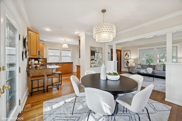 4628 Grand Ave, Western Springs, IL 60558 - dining area featuring ornamental molding, a chandelier, light wood-style flooring, and recessed lighting