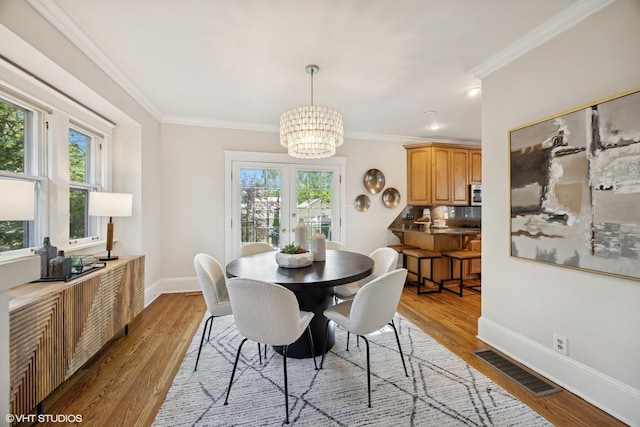 4628 Grand Ave, Western Springs, IL 60558 - dining space with a chandelier, healthy amount of natural light, crown molding, wood finished floors, and recessed lighting
