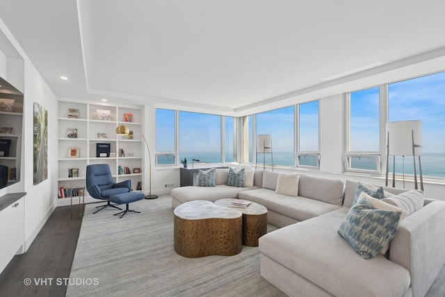 1300 N Lake Shore Dr Unit 21D, Chicago, IL 60610 - living room featuring wood finished floors, a water view, recessed lighting, and built in shelves