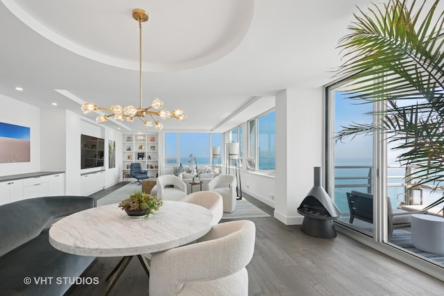 1300 N Lake Shore Dr Unit 21D, Chicago, IL 60610 - dining room featuring a chandelier, wood finished floors, built in shelves, recessed lighting, and a water view