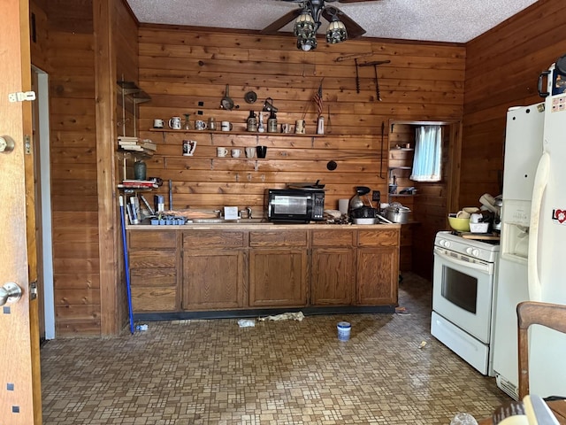 7005 34th St, Berwyn, IL 60402 - kitchen with white appliances, wooden walls, a ceiling fan, and a textured ceiling