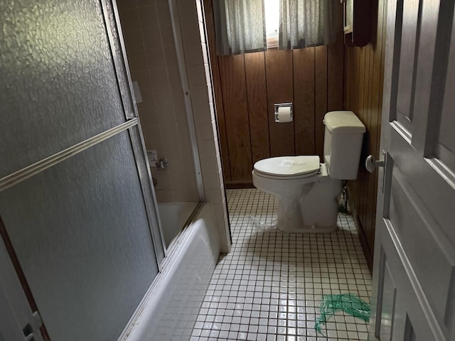 7005 34th St, Berwyn, IL 60402 - bathroom featuring tile patterned floors, bath / shower combo with glass door, and wood walls