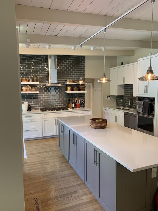 743 Dundee Ave, Barrington, IL 60010 - kitchen with wall chimney range hood, stainless steel appliances, backsplash, open shelves, and white cabinetry