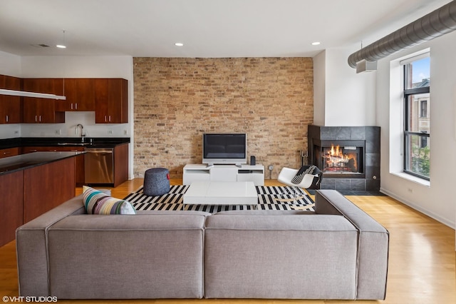 1525 N Milwaukee Ave Unit 3, Chicago, IL 60622 - living area featuring light wood-style flooring, plenty of natural light, a tiled fireplace, and recessed lighting