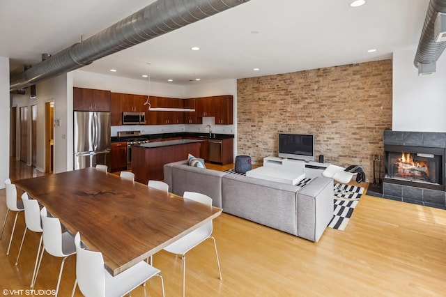 1525 N Milwaukee Ave Unit 3, Chicago, IL 60622 - living room with light wood-type flooring, recessed lighting, and a warm lit fireplace