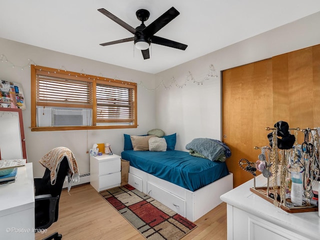 6737 W Lloyd Dr, Worth, IL 60482 - bedroom with light wood finished floors, ceiling fan, and baseboard heating