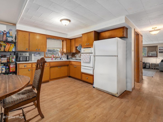 6737 W Lloyd Dr, Worth, IL 60482 - kitchen featuring white appliances, a warming drawer, light countertops, light wood-style flooring, and brown cabinetry