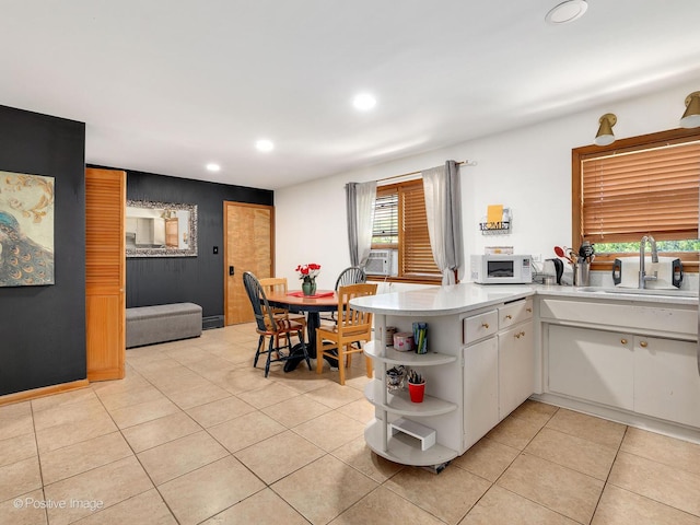 6737 W Lloyd Dr, Worth, IL 60482 - kitchen with open shelves, white microwave, recessed lighting, light tile patterned floors, and light countertops