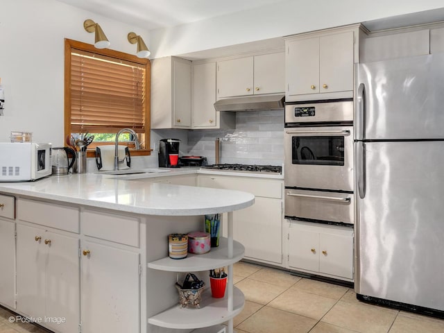 6737 W Lloyd Dr, Worth, IL 60482 - kitchen featuring appliances with stainless steel finishes, a warming drawer, open shelves, under cabinet range hood, and light countertops