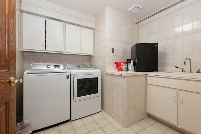 24029 S Plum Valley Dr, Crete, IL 60417 - laundry room with tile walls, washing machine and clothes dryer, light tile patterned floors, and cabinet space