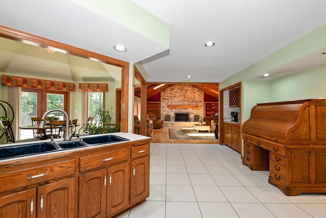 24029 S Plum Valley Dr, Crete, IL 60417 - kitchen featuring brown cabinetry, open floor plan, light tile patterned floors, a brick fireplace, and recessed lighting