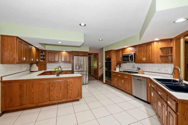 24029 S Plum Valley Dr, Crete, IL 60417 - kitchen featuring stainless steel appliances, a peninsula, backsplash, open shelves, and brown cabinets