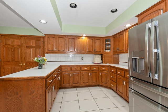 24029 S Plum Valley Dr, Crete, IL 60417 - kitchen with stainless steel fridge, brown cabinets, light countertops, a peninsula, and decorative backsplash
