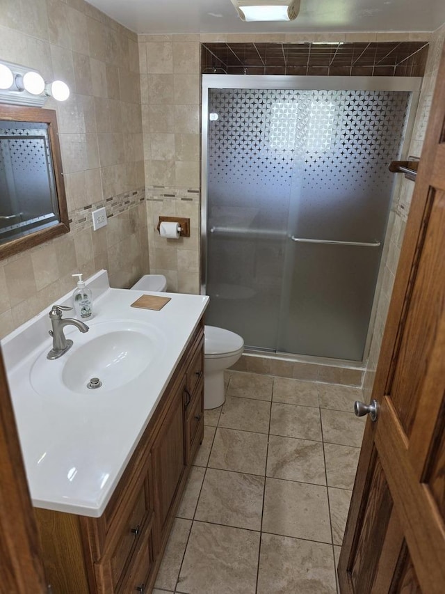 17936 66th Ave, Tinley Park, IL 60477 - bathroom with tile walls, a shower stall, vanity, and tile patterned floors