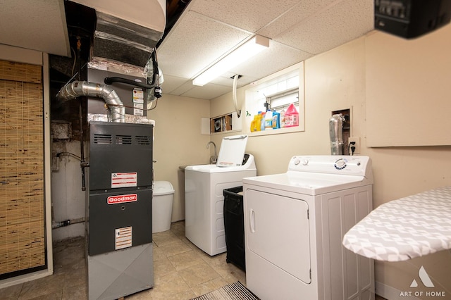 7707 Moody Ave, Burbank, IL 60459 - laundry room featuring separate washer and dryer, light tile patterned floors, and heating unit