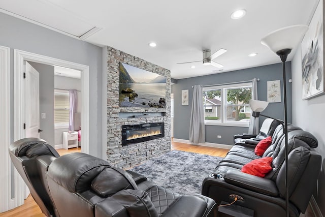 1715 N 15th Ave, Melrose Park, IL 60160 - living area featuring light wood-style flooring, a ceiling fan, a stone fireplace, and recessed lighting