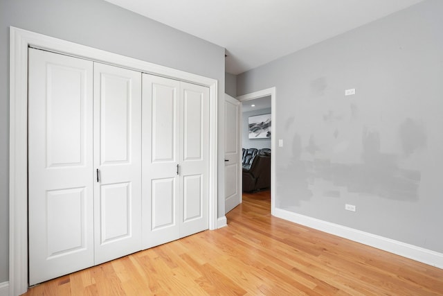1715 N 15th Ave, Melrose Park, IL 60160 - unfurnished bedroom with light wood-style floors and a closet