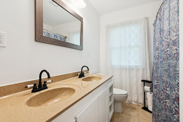 bathroom featuring double vanity and tile patterned flooring