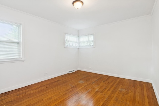 unfurnished room featuring light wood finished floors and ornamental molding