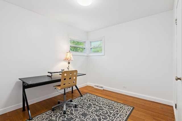 home office with wood finished floors