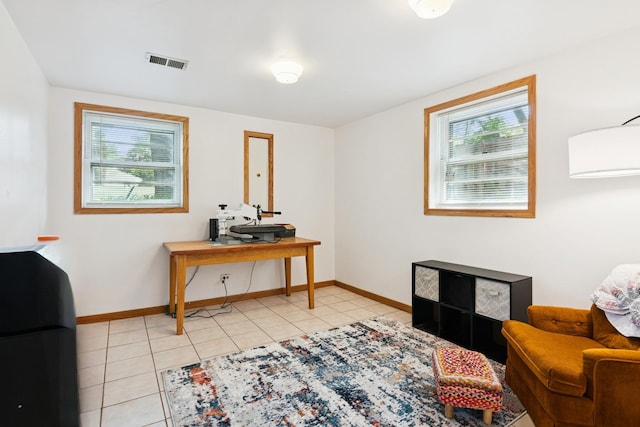 living area with light tile patterned floors, plenty of natural light, and an office area