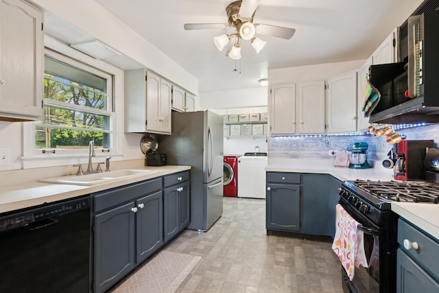 kitchen with independent washer and dryer, black appliances, ceiling fan, and light countertops