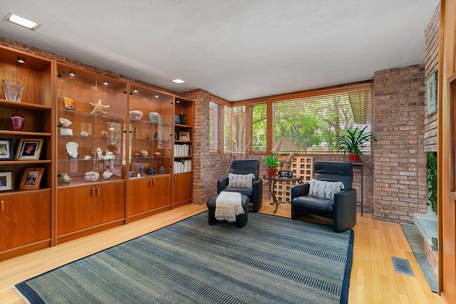 1200 Regency Ln, Lake Forest, IL 60045 - sitting room with brick wall and wood finished floors