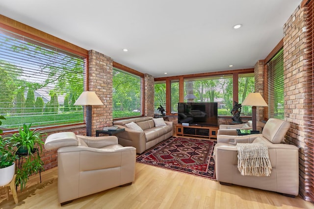 1200 Regency Ln, Lake Forest, IL 60045 - living room featuring plenty of natural light, brick wall, wood finished floors, and recessed lighting