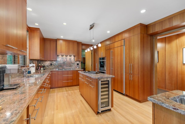 1200 Regency Ln, Lake Forest, IL 60045 - kitchen featuring wine cooler, brown cabinets, paneled refrigerator, light wood-style flooring, and recessed lighting