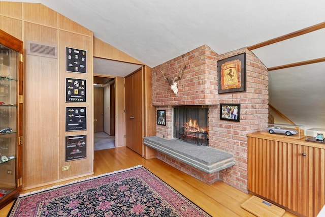 1200 Regency Ln, Lake Forest, IL 60045 - living area with vaulted ceiling, wood finished floors, and a brick fireplace