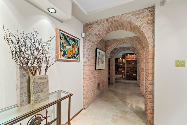 1200 Regency Ln, Lake Forest, IL 60045 - corridor with arched walkways, stone finish floors, and brick wall