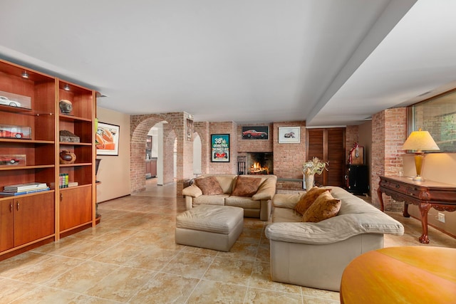 1200 Regency Ln, Lake Forest, IL 60045 - living area featuring brick wall, a brick fireplace, arched walkways, and light tile patterned floors