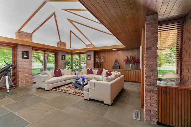1200 Regency Ln, Lake Forest, IL 60045 - living area with high vaulted ceiling, stone tile flooring, brick wall, and wood ceiling