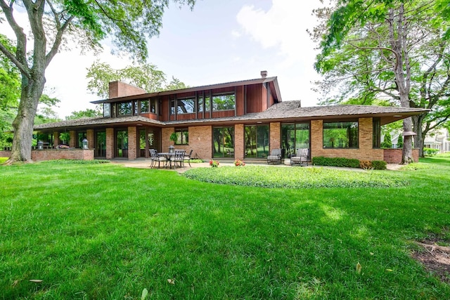 1200 Regency Ln, Lake Forest, IL 60045 - rear view of property featuring brick siding, a yard, a chimney, and a patio area