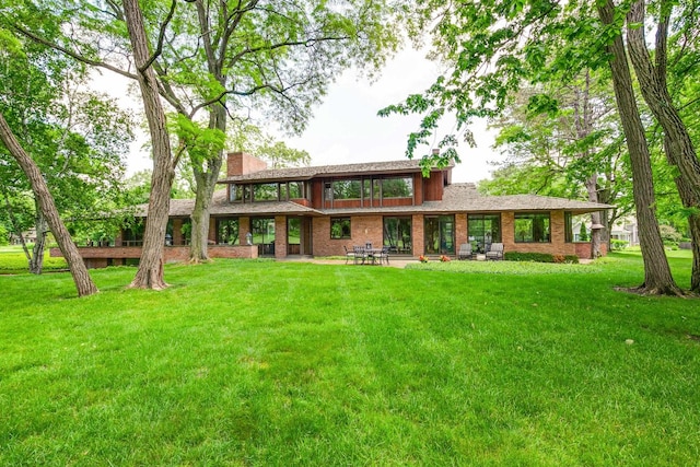 1200 Regency Ln, Lake Forest, IL 60045 - back of house with a lawn, a chimney, and brick siding