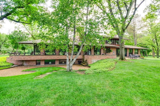 1200 Regency Ln, Lake Forest, IL 60045 - rear view of property featuring brick siding and a lawn