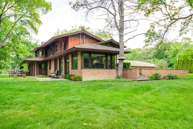 1200 Regency Ln, Lake Forest, IL 60045 - back of property with brick siding, a patio, a yard, and a chimney