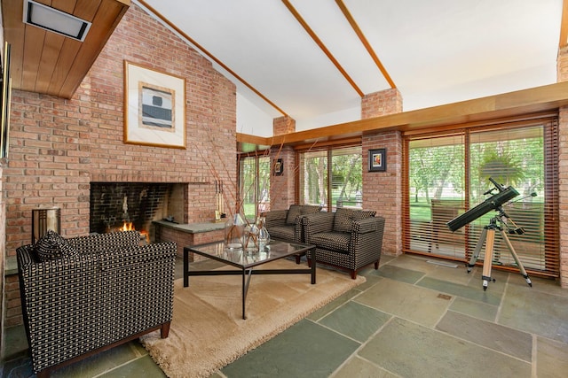 1200 Regency Ln, Lake Forest, IL 60045 - living room featuring stone tile floors, brick wall, high vaulted ceiling, and a fireplace