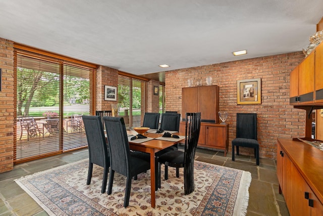 1200 Regency Ln, Lake Forest, IL 60045 - dining room featuring brick wall, stone tile flooring, and a fireplace