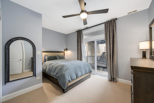 4259 N Ashland Ave Unit 2, Chicago, IL 60613 - carpeted bedroom featuring access to outside and ceiling fan