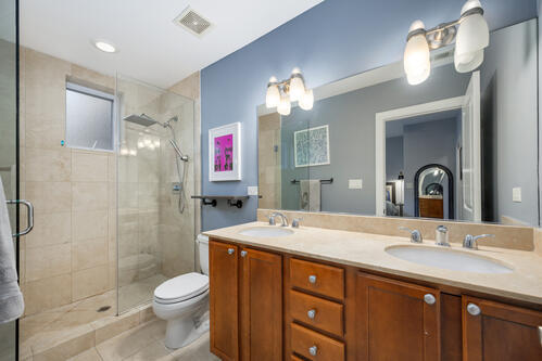 4259 N Ashland Ave Unit 2, Chicago, IL 60613 - bathroom with a shower stall, double vanity, and tile patterned floors