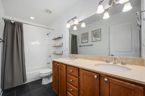 4259 N Ashland Ave Unit 2, Chicago, IL 60613 - bathroom with tile patterned flooring, double vanity, and shower / tub combo