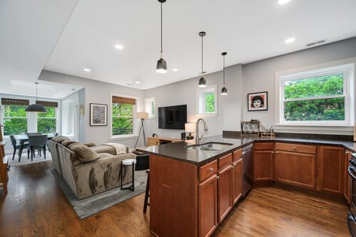 4259 N Ashland Ave Unit 2, Chicago, IL 60613 - kitchen featuring brown cabinetry, stainless steel dishwasher, healthy amount of natural light, open floor plan, and recessed lighting